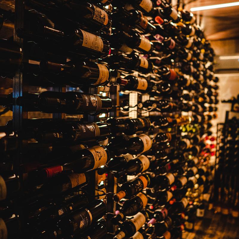 Rows of wine bottles in a wall rack