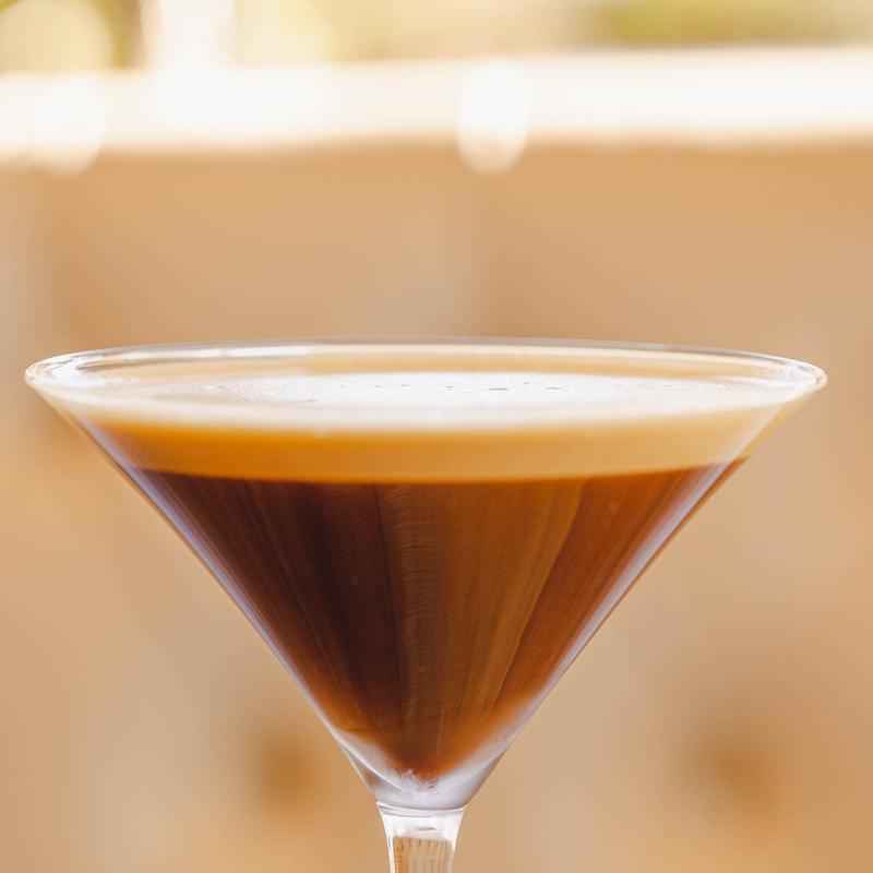 Brown cocktail in a martini glass
