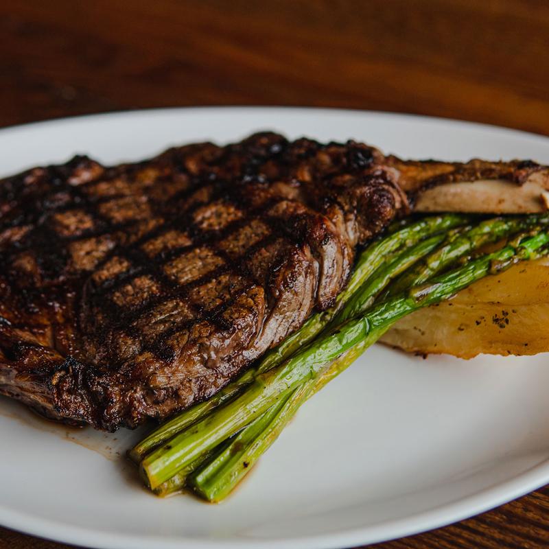 Grilled bone-in steak with asparagus