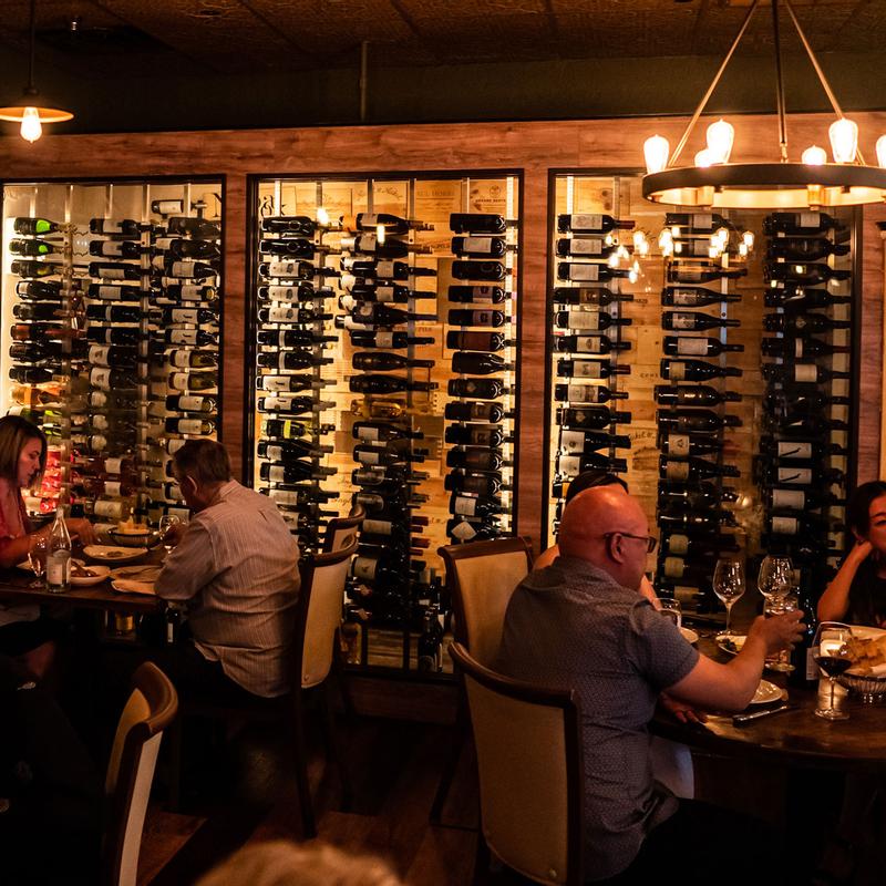 Diners seated beside the wine display